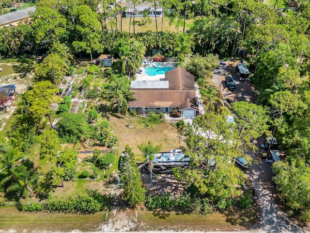 aerial view of property and surrounding area featuring a pool