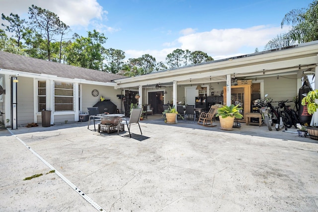rear view of property featuring ceiling fan, a patio, and outdoor dining area