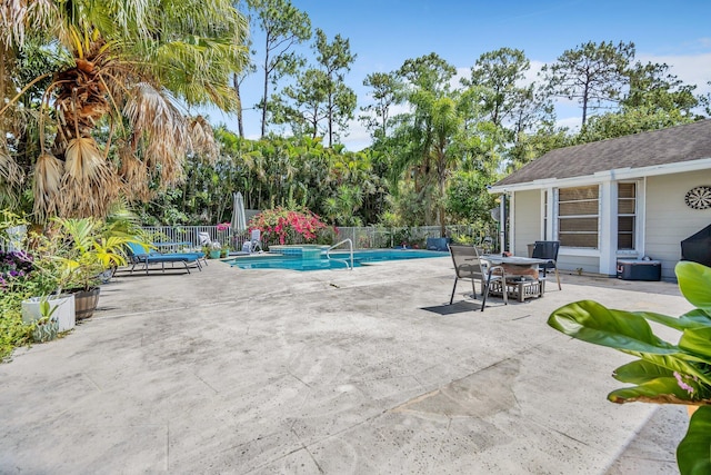 view of swimming pool featuring fence and a patio