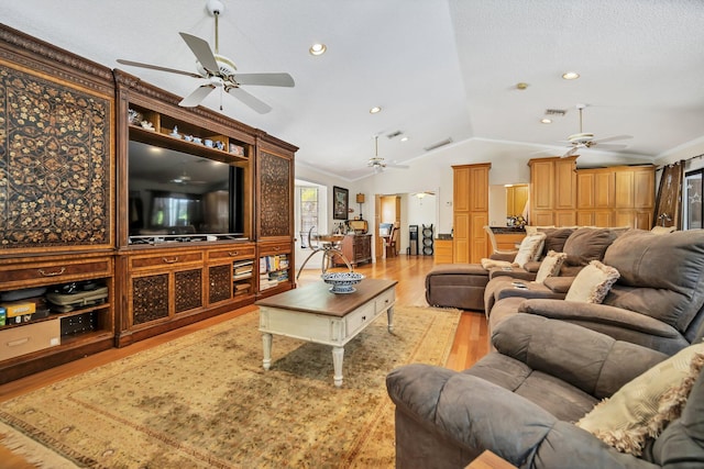 living room with a ceiling fan, light wood-type flooring, vaulted ceiling, ornamental molding, and recessed lighting