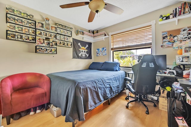 bedroom with wood finished floors and a ceiling fan