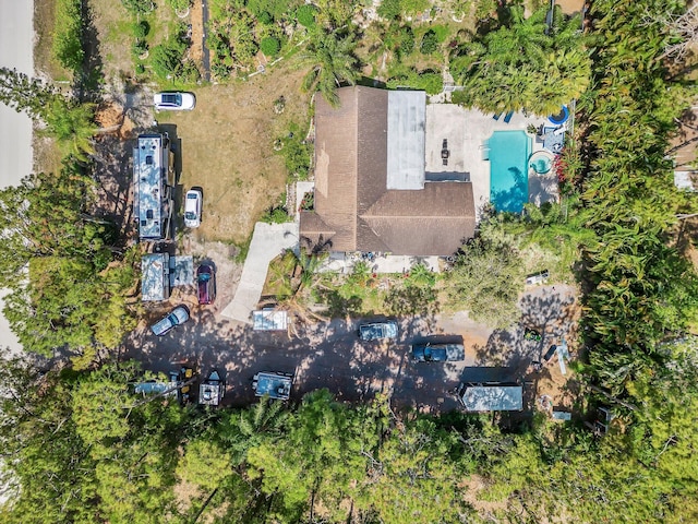 aerial view of property and surrounding area with a pool area
