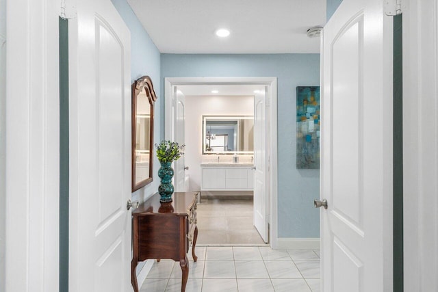 hallway featuring recessed lighting and baseboards