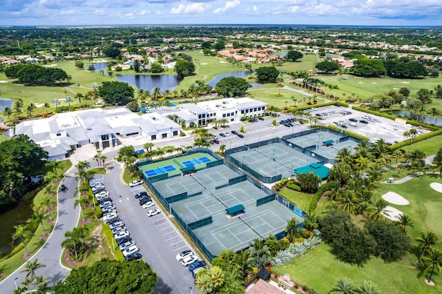drone / aerial view of a local golf course and a large body of water