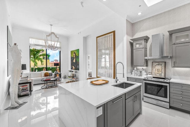 kitchen with stainless steel electric range oven, gray cabinetry, wall chimney exhaust hood, a sink, and light countertops