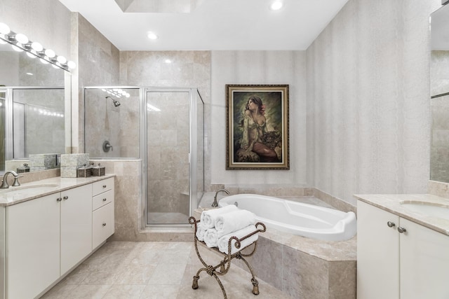 full bath featuring a stall shower, two vanities, a garden tub, and recessed lighting