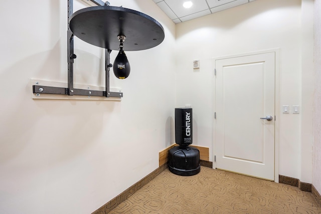 detailed view of baseboards and a drop ceiling