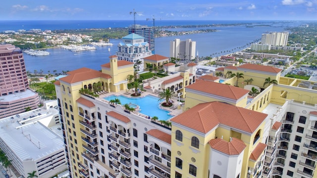 view of urban area with a pool and a large body of water