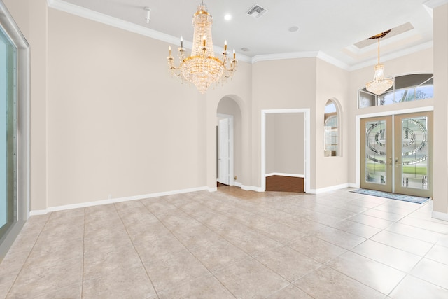 tiled foyer entrance featuring arched walkways, crown molding, a chandelier, french doors, and baseboards