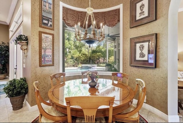 dining space with a chandelier, baseboards, and tile patterned floors