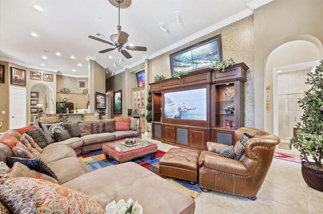 tiled living room with arched walkways, recessed lighting, crown molding, and a ceiling fan