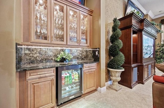 indoor dry bar with beverage cooler, ornamental molding, and backsplash