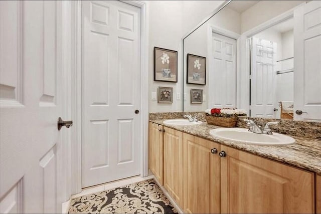 bathroom featuring double vanity and tile patterned flooring