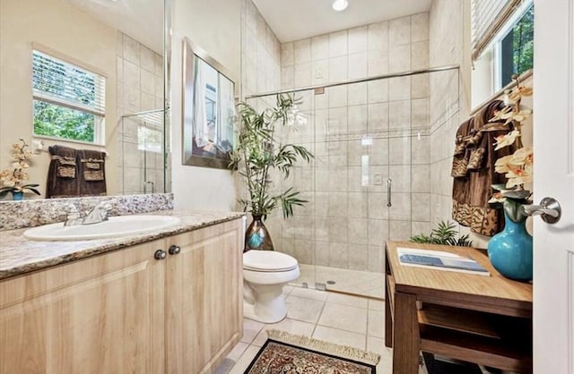 bathroom with a shower stall, vanity, toilet, tile patterned flooring, and recessed lighting