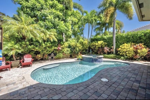 view of swimming pool with a patio area and a pool with connected hot tub