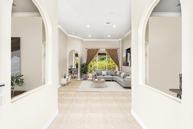 tiled living area with crown molding, baseboards, recessed lighting, and arched walkways