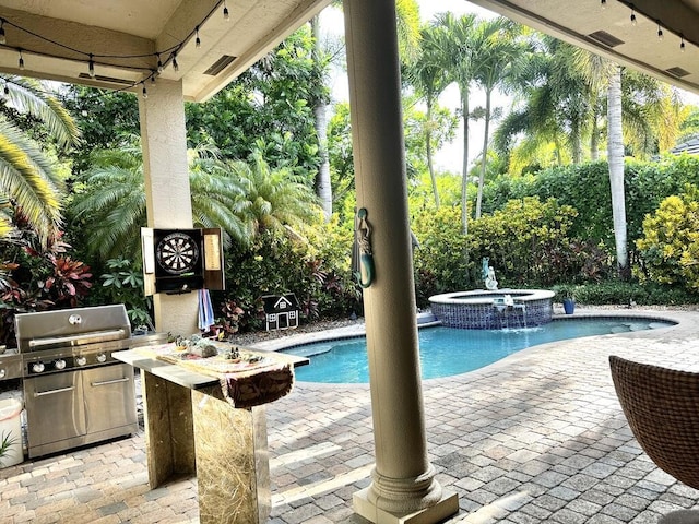 view of pool with a patio, a grill, and a pool with connected hot tub