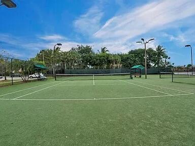 view of tennis court with fence