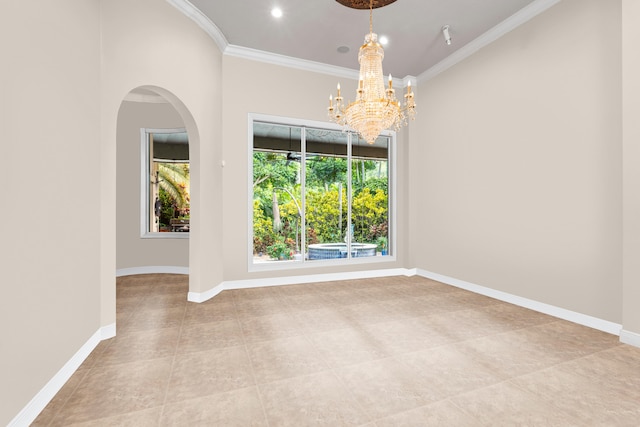 spare room featuring a chandelier, crown molding, baseboards, arched walkways, and light tile patterned flooring