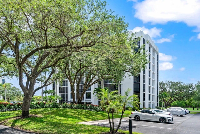 view of apartment building / complex featuring uncovered parking