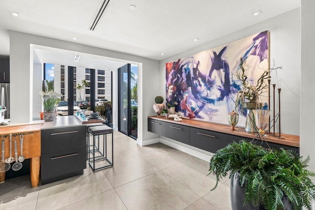 dining space with light tile patterned flooring and recessed lighting