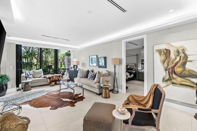 living room featuring light tile patterned flooring and a wall of windows