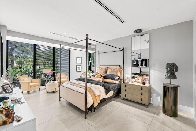 bedroom with multiple windows and light tile patterned floors