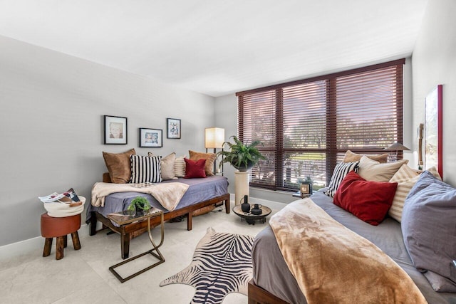 bedroom featuring baseboards and light colored carpet