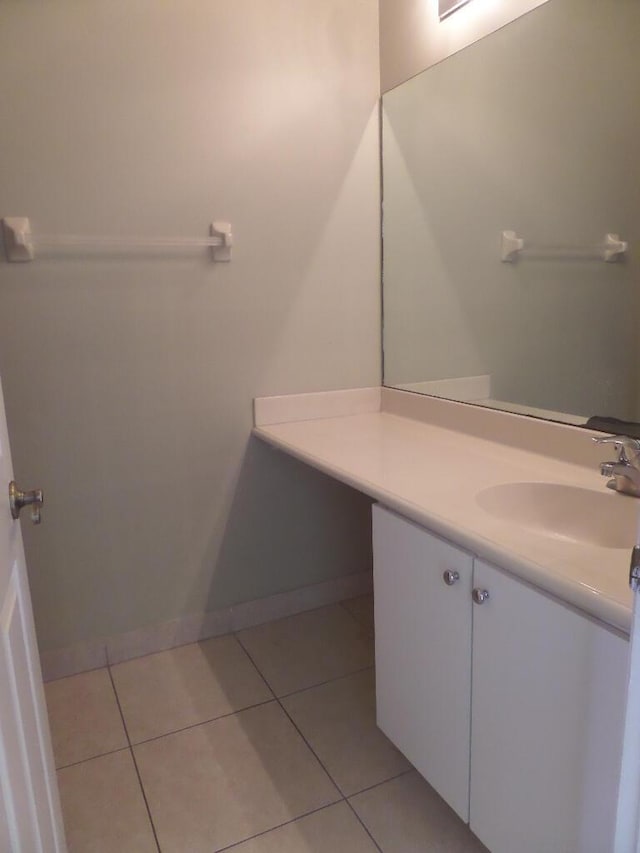 bathroom with vanity, tile patterned floors, and baseboards