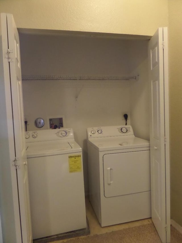 clothes washing area with washing machine and dryer