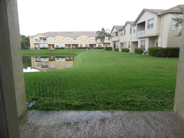 view of home's community with a residential view and a lawn