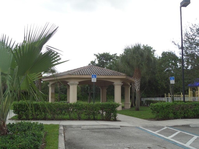 view of home's community with a gazebo and fence