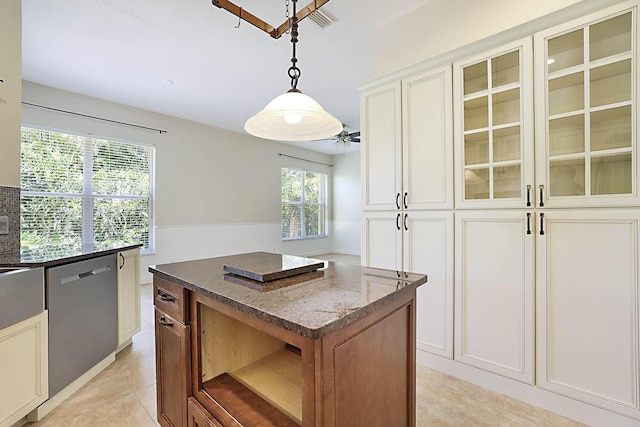 227 Shorewood Way, Jupiter, FL 33458 - kitchen featuring dishwasher, dark stone counters, a kitchen island, open shelves, and hanging light fixtures
