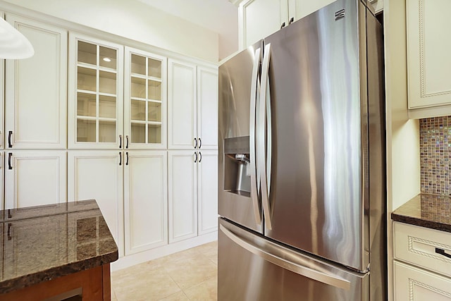227 Shorewood Way, Jupiter, FL 33458 - kitchen featuring stainless steel fridge with ice dispenser, dark stone countertops, glass insert cabinets, and backsplash