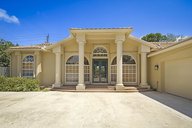 227 Shorewood Way, Jupiter, FL 33458 - property entrance featuring french doors, a tile roof, stucco siding, and driveway