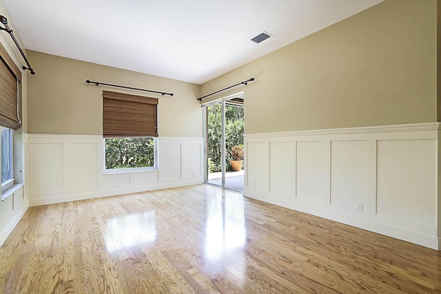 227 Shorewood Way, Jupiter, FL 33458 - spare room featuring a decorative wall, light wood finished floors, and a wainscoted wall