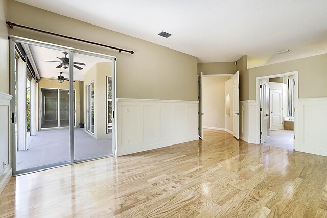 227 Shorewood Way, Jupiter, FL 33458 - unfurnished room with wood finished floors, a wainscoted wall, a ceiling fan, and a decorative wall