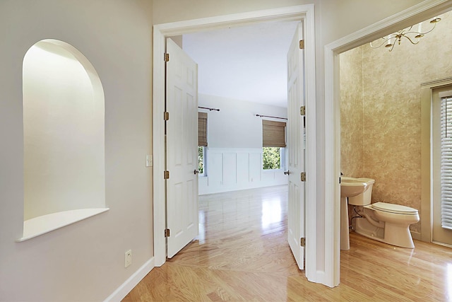 227 Shorewood Way, Jupiter, FL 33458 - hallway with arched walkways and light wood finished floors