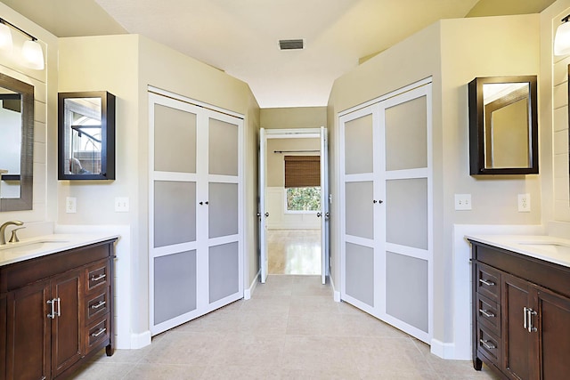 227 Shorewood Way, Jupiter, FL 33458 - bathroom with two vanities, french doors, baseboards, and tile patterned floors