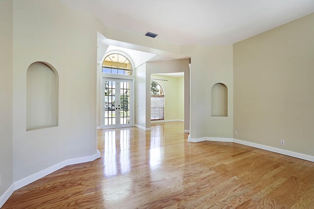 227 Shorewood Way, Jupiter, FL 33458 - unfurnished room featuring light wood finished floors, baseboards, and french doors