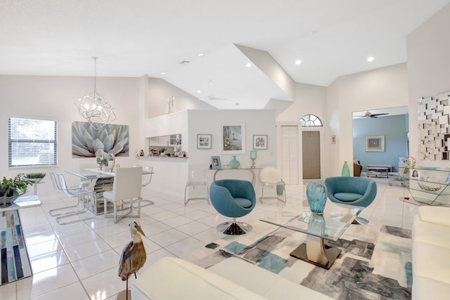 tiled living area featuring a ceiling fan, high vaulted ceiling, a chandelier, and recessed lighting