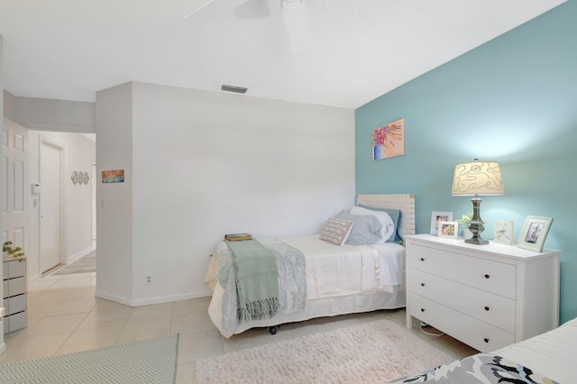 bedroom featuring light tile patterned flooring, baseboards, and ceiling fan