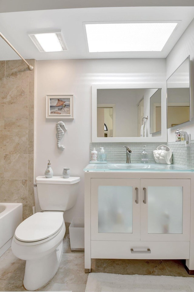 bathroom with decorative backsplash, toilet, vanity, and shower / bath combination