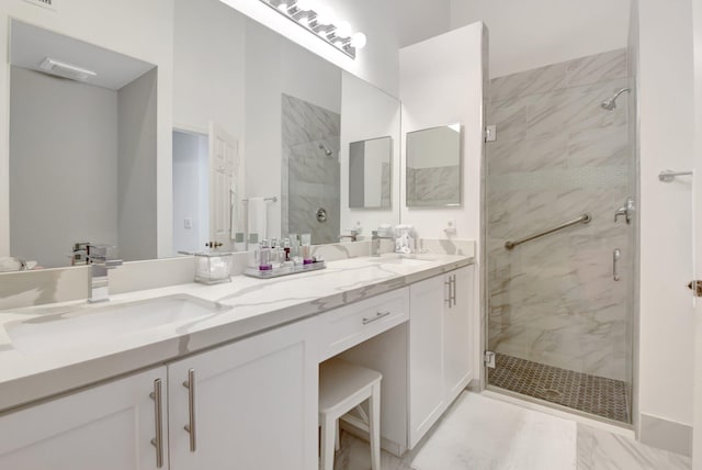 bathroom featuring a marble finish shower and double vanity