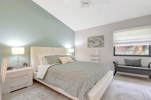 bedroom with light tile patterned floors and lofted ceiling
