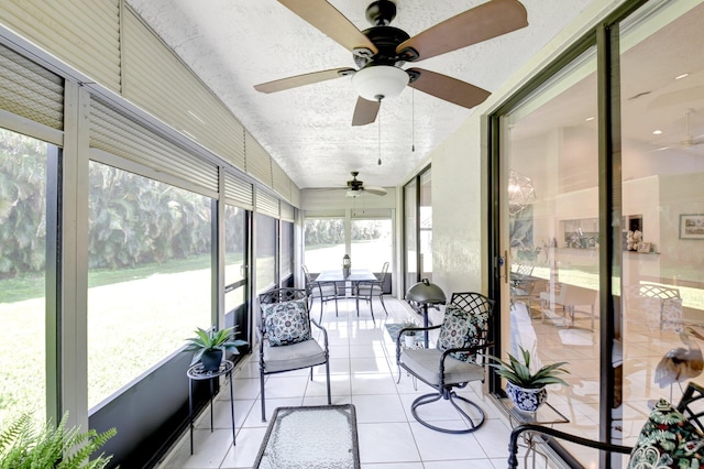 sunroom / solarium with a ceiling fan
