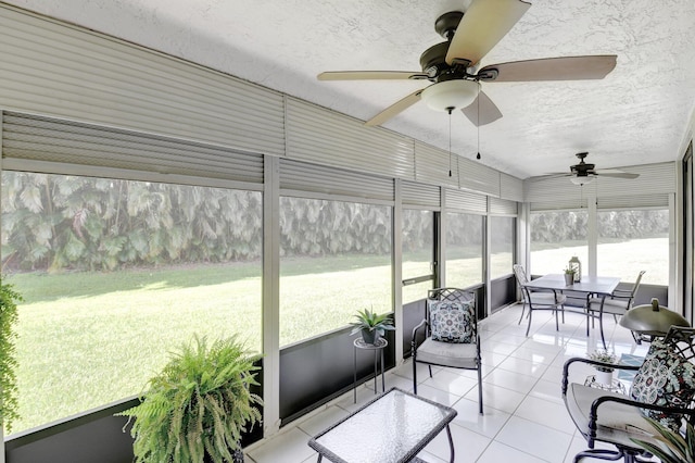 sunroom featuring ceiling fan