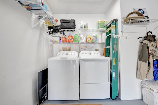 clothes washing area with washer and dryer