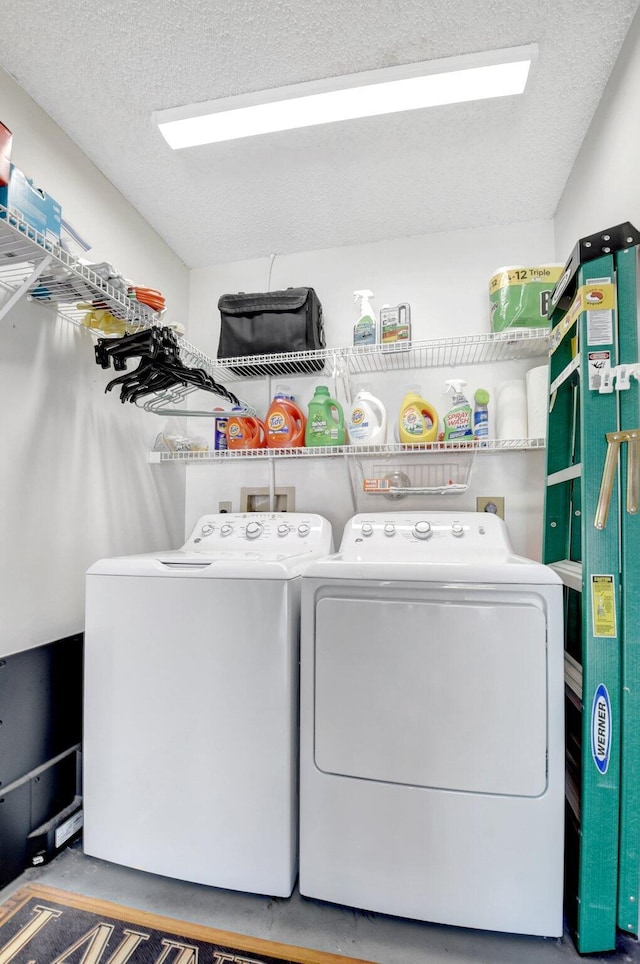 washroom featuring washer and dryer and a textured ceiling