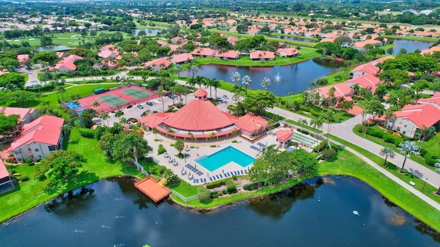 aerial view of residential area featuring a pool and a nearby body of water